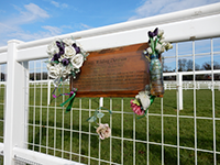 A photo showing the memorial plaque at Epsom Downs Racecourse.